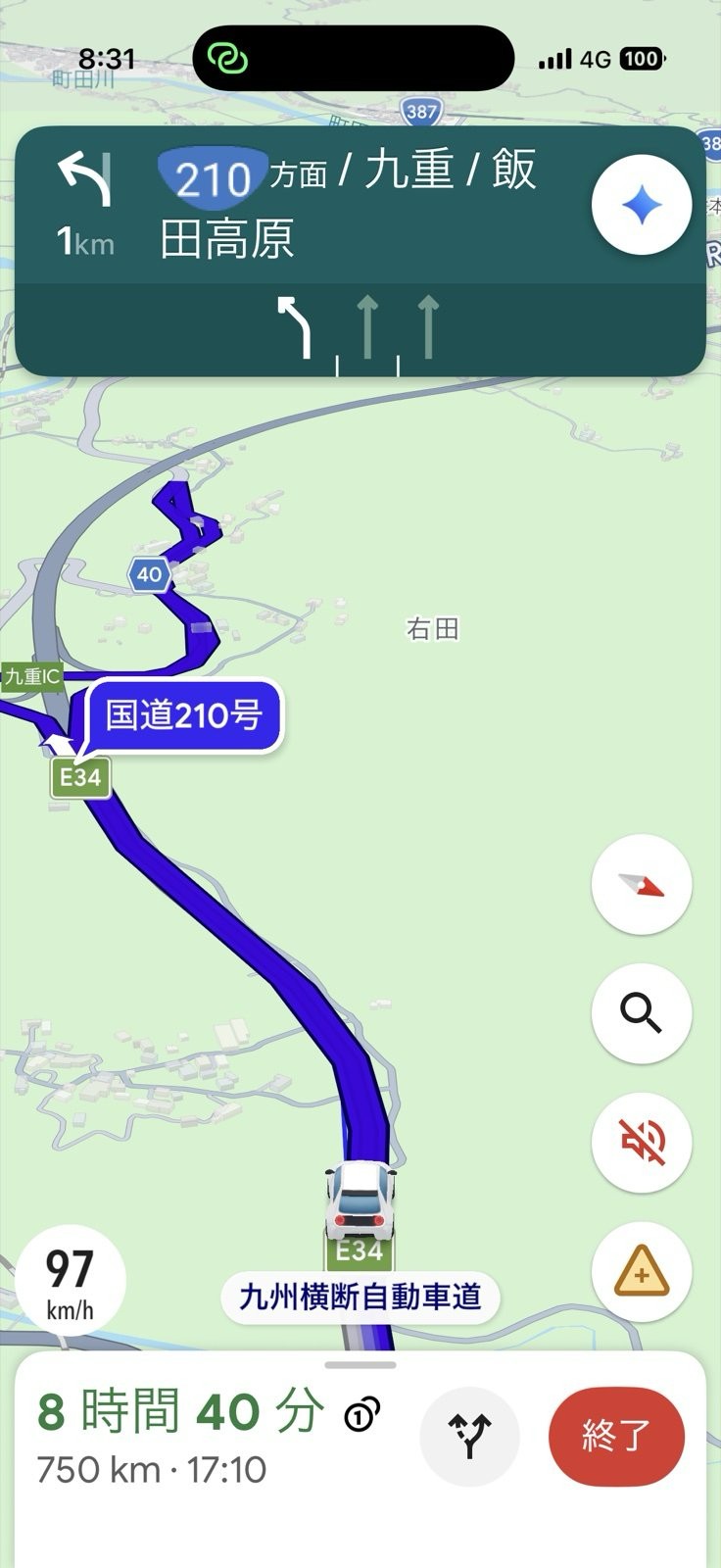 朝日でナビが見えなくなる中、進行方向の青いラインが九重の手前でクネクネと折り返しており、道を間違えたことに気づいた瞬間。国道210号方面、残り750km、到着予定17時10分の表示